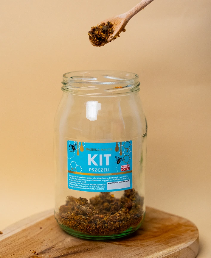 Czysty surowy kit pszczeli propolis 50g z Pasieki Mnich w małym słoiczku na drewnianym stole.